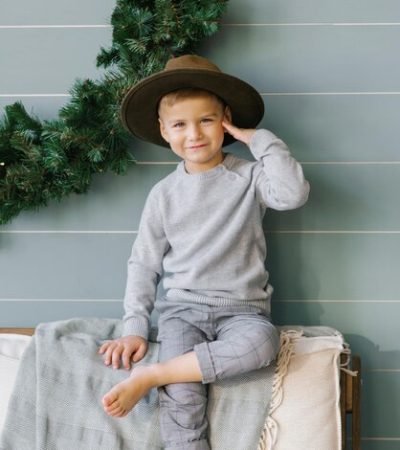 prankster-happy-child-boy-is-sitting-sofa-hat-that-he-took-from-his-mother-person_1048944-29637940